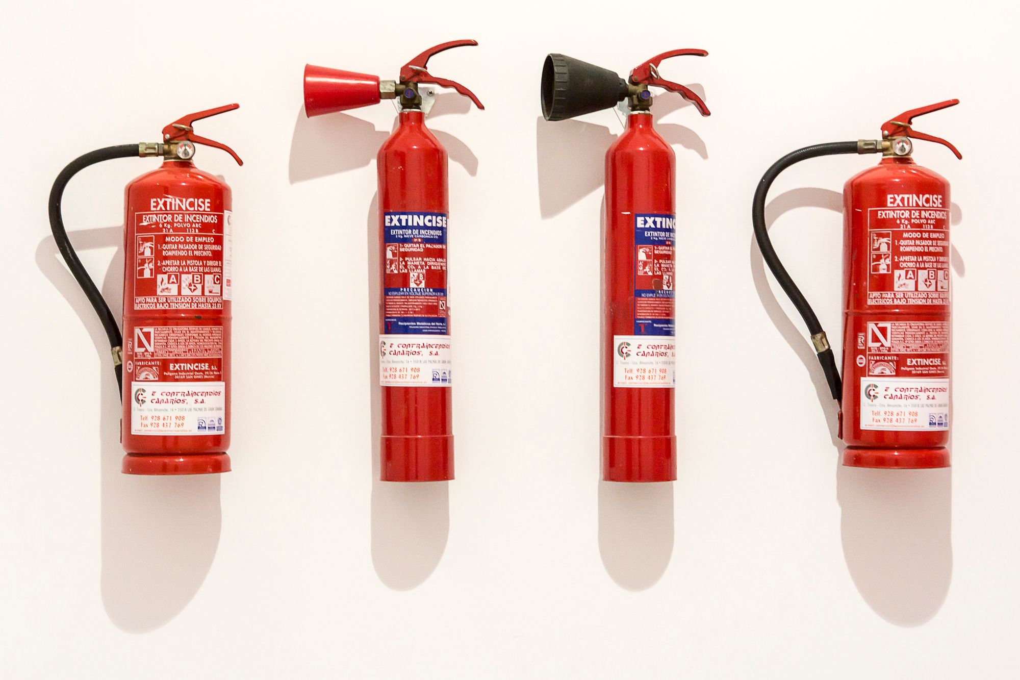 Red fire extinguishers mounted on a wall
